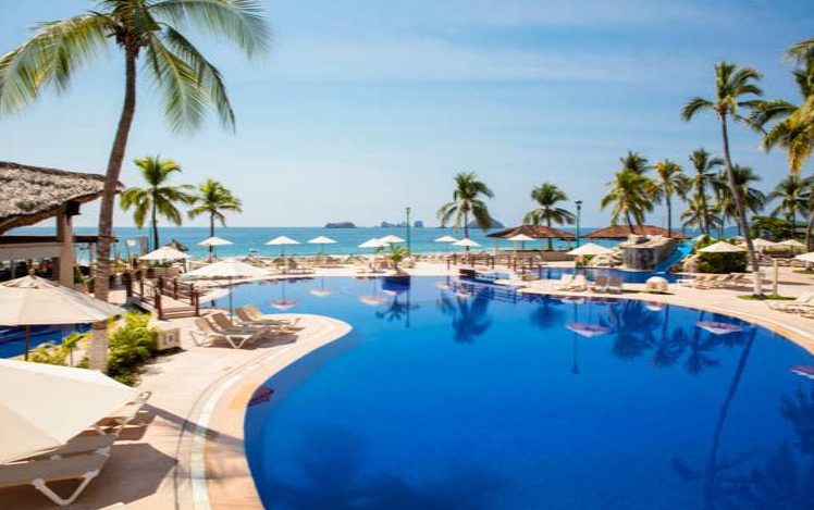 Hotel Krystal Ixtapa Todo Incluido, Nuestra área de la alberca es considerada como una de las piscinas más singulares y bellas de Ixtapa, Cuenta con una cascada de rocas, un bar, zonas para practicar deportes acuáticos y un estupendo tobogán de agua para los niños